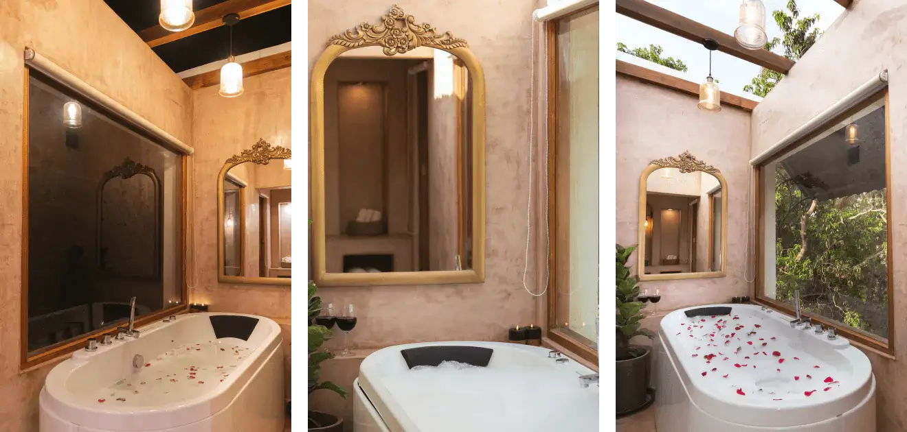 The image shows a luxurious bathroom with a bathtub adorned with rose petals, a large mirror with an ornate frame, and natural lighting.