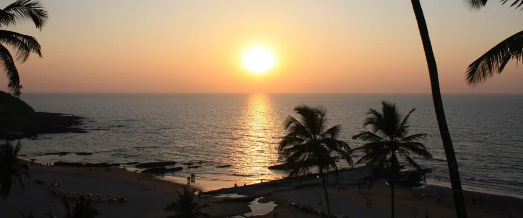 A picturesque sunset in Goa in December, as the sun dips below the horizon, bathes the ocean in a mesmerizing golden glow.