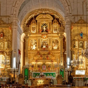 Ornate golden altar and decorations inside a baroque-style church.